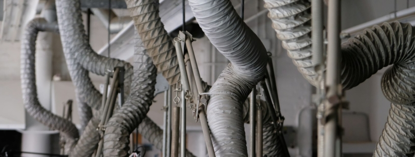Conductos de ventilación flexibles colgando de un techo